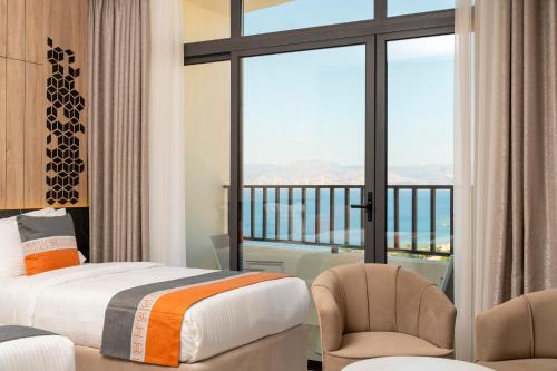 a hotel room with a bed and a balcony at Diamond Palm Hotel & Resort in Al Burj