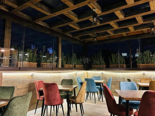 a row of tables and chairs in a restaurant at Parliament Hotel & Restaurant in Baku