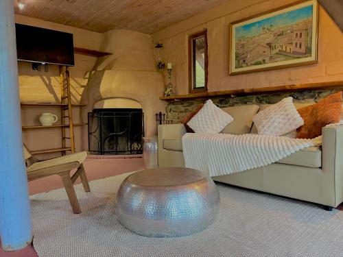 a living room with a couch and a table at Maccys Cottages in Macclesfield