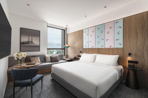 a hotel room with a bed and a couch at Crowne Plaza Penang Straits City by IHG in Perai