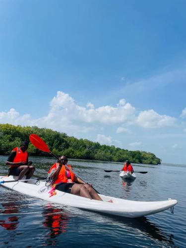 a group of people sitting on a kayak in the water at Kirepwe Ecco Camp Watamu in Watamu