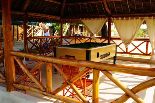 a room with a pool table in a hut at Kirepwe Ecco Camp Watamu in Watamu