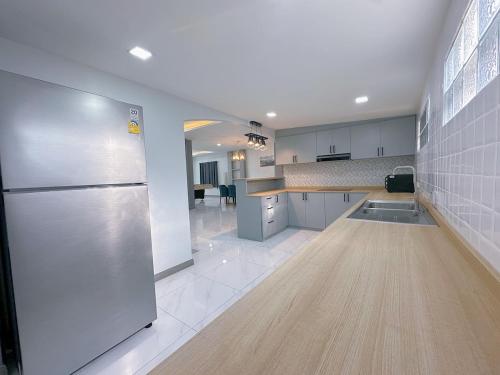 Il comprend une grande cuisine équipée d'un réfrigérateur et d'un comptoir. dans l'établissement AnJia Villa, à Pattaya (sud)