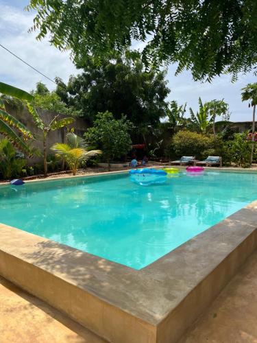 a large swimming pool with blue water at Binta Boutique Hotel - Small Oasis near Nungwi Beach in Nungwi