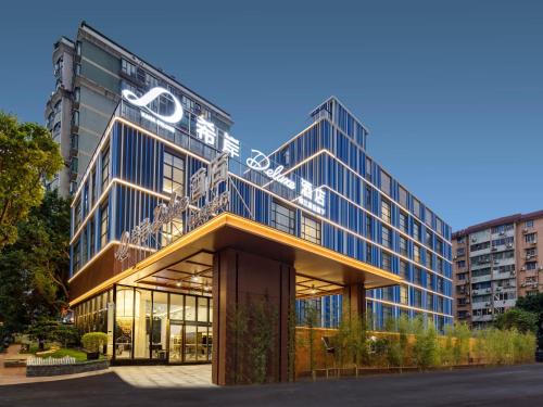 a building with a sign on the front of it at Pazhou XANA Deluxe International Hotel Pazhou Convention and Exhibition Center Nanzhou Metro Station Branch - Free Shuttle Bus to Canton Fair Complex During Canton Fair Period in Guangzhou