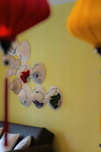 a group of plates hanging on a wall at DingD0ng Home FelizEnVista 5-star facilities in Ho Chi Minh City