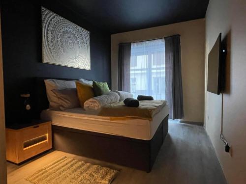 a bedroom with a large bed with a window at Ancram SPA Miskolc in Miskolc