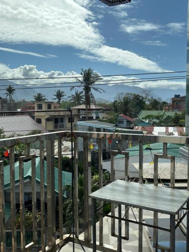 a balcony with a table and a view of a city at Reese Place Baler in Baler