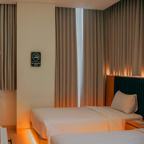 The Risman Hotel At Jakarta Airport CBCにあるベッド