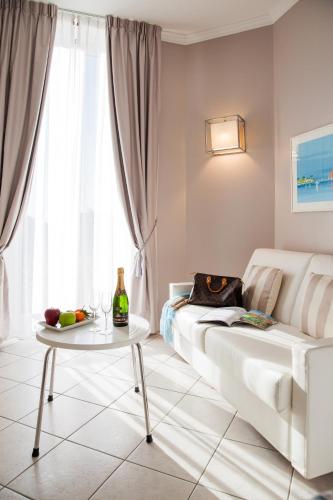 a living room with a white couch and a table at Albergo Belsoggiorno in Sanremo