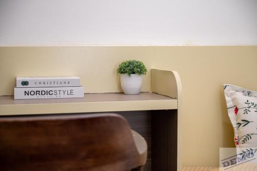 a plant sitting on a shelf in a room at Luxe Paradise Residence 273 Ton Duc Thang in Hanoi