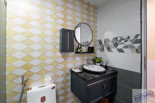 a bathroom with a sink and a mirror at Luxe Paradise Residence 273 Ton Duc Thang in Hanoi