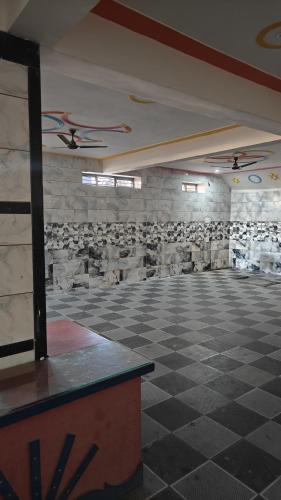 an empty room with a stone wall and ceiling at Ashirwad Hotel And Family Restaurant in Rīngas