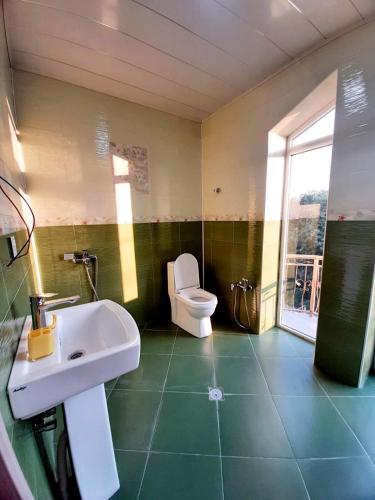 a bathroom with a white sink and a toilet at Samira's house Gusar in Hǝsǝnqala
