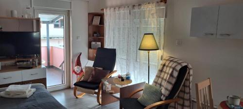 a living room with a couch and chairs and a television at Srce Turopolja in Velika Gorica