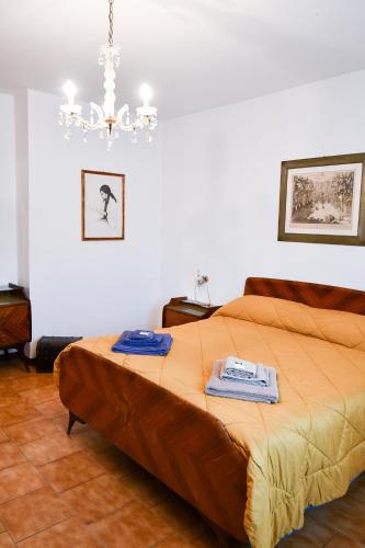 a bedroom with a bed with two towels on it at CàGrande in Colombara