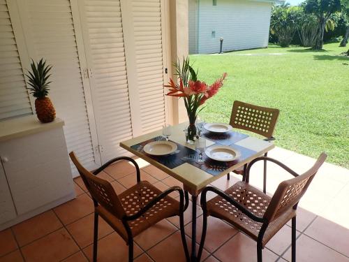 a table and four chairs on a patio at PIERRE & VACANCES Antigua 03 in Sainte-Luce