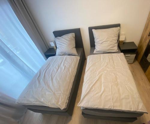Ένα ή περισσότερα κρεβάτια σε δωμάτιο στο Hindenburg Apartments