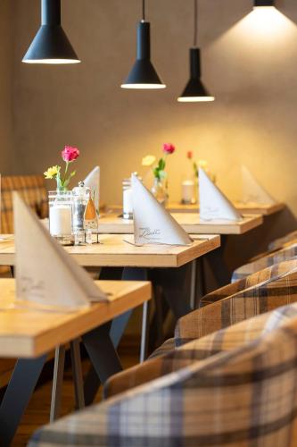a row of tables in a restaurant with laptops on them at Landgasthof Linde - In ruhiger, ländlicher Umgebung in Deggenhausertal