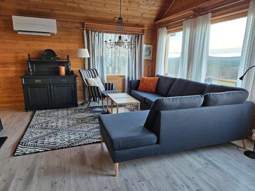 a living room with a couch and a chair at The view of Skattungbyn in Skattungbyn