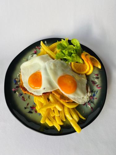 a plate of food with eggs and french fries at Hotel Römerstein in Loipersdorf bei Fürstenfeld