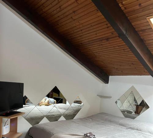 a bedroom with two beds and a flat screen tv at Casa Parco Dora Torino - Intero Monolocale vicino al Centro e Allianz Stadium Juventus in Turin