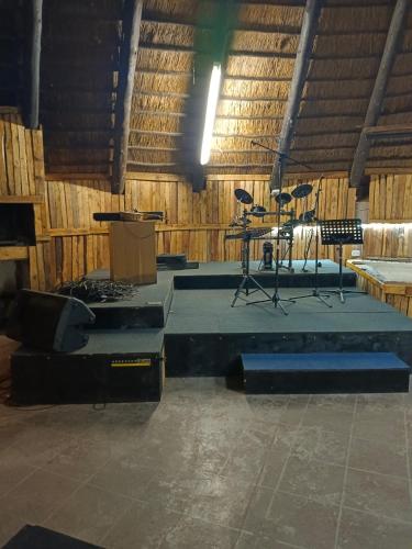 a large room with a stage and chairs in it at Limpopo Lodge in Polokwane