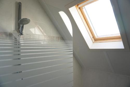 a bathroom with a shower and a window at Kustverhuur, Park Schoneveld, Stern 233 in Breskens