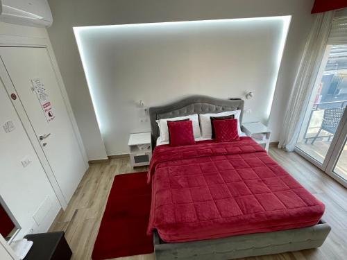 a bedroom with a red bed with a red blanket at ARBI VENICE STATiON in Mestre