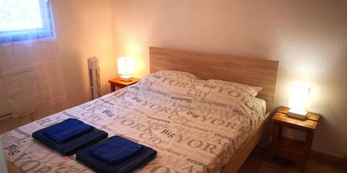 une chambre avec un lit avec deux serviettes bleues dessus dans l'établissement Résidence Cap Azur Maison N° 106, à Villeneuve-Loubet