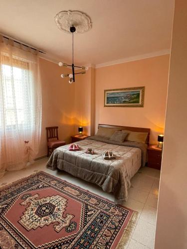 a bedroom with a bed and a rug on the floor at Iolly's House in Livorno