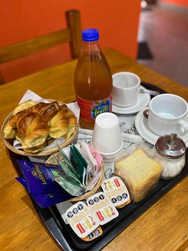 a tray of food on a table with a bottle of drink at Hotel Complejo Del Carmen San Bernardo in San Bernardo