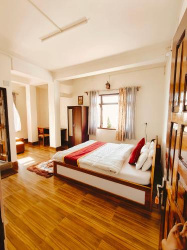 a bedroom with a large bed in a room at Jain Homestay in Darjeeling