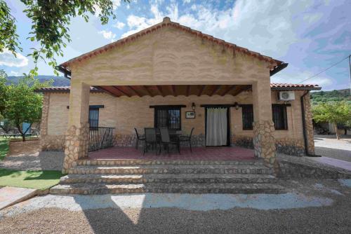 a small stone house with a porch and stairs at El Valle de Yeste in Yeste