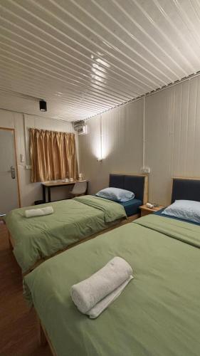 Postel nebo postele na pokoji v ubytování 5 Minutes Lodge