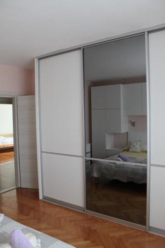a sliding glass door in a room with a bedroom at Spacious Green Home in Hvar