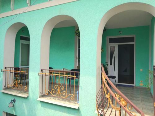 two arches on a building with a balcony at Guest House Sirius in Chişinău