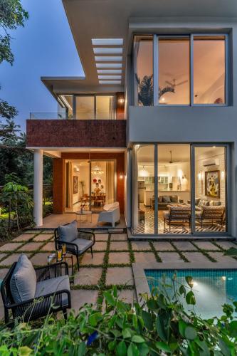 an exterior view of a house with a pool at La Masillia, 2 BHK with Private Pool, 15 mins from Morjim Beach, Wifi, Peaceful location, Kitchen, Security, Patio in Siolim