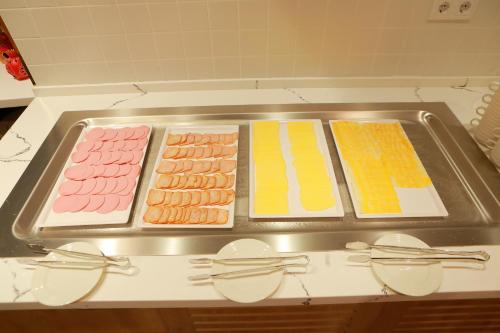 a tray of different types of food on a stove at Hilton Garden Inn Termez Airitom in Termiz