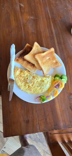 a plate of breakfast food with toast and eggs at White Lion Paradise Dikwella in Batigama