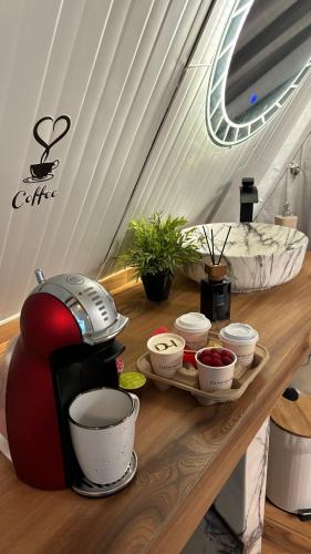 a coffee maker on a table with bowls of food at Bidiya Desert Camp in Aflāj