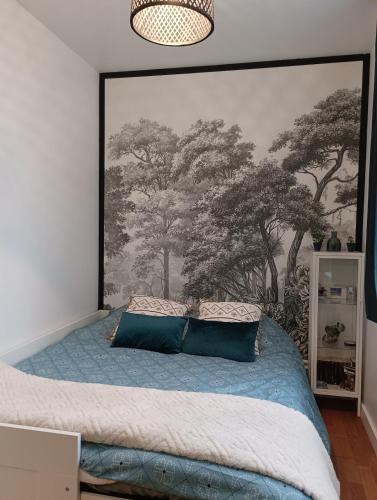 - une chambre ornée d'une grande fresque murale représentant des arbres dans l'établissement Studio Ault, à Ault