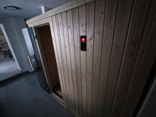 a wooden wall with a red light on it at Černý Potok 59 in Kryštofovy Hamry