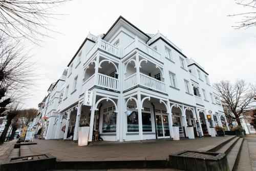 a large white building on a city street at Villa Laetitia Whg 24 in Binz