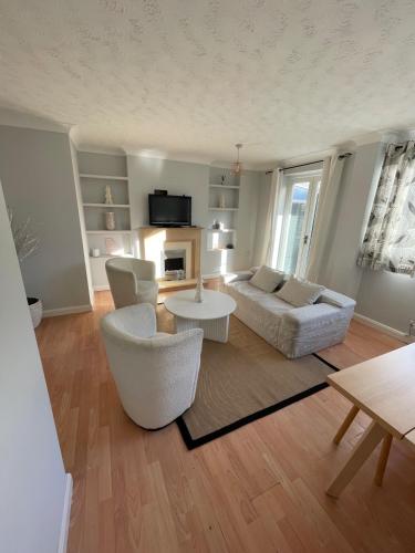a living room with a couch and chairs and a table at 3-Bed House Sleeps 5 w Garden Parking & Pets Ok in Norwich