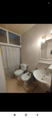 a bathroom with a toilet and a sink at Casa Ani in Amposta