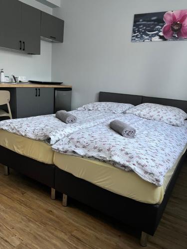 a bed with two pillows on it in a room at Dom Wypoczynkowy Nad Wisłą in Puławy