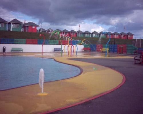 a playground with a pool of water in a park at 6 Berth pet friendly Chalet in Mablethorpe