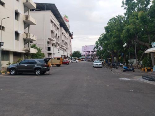 a city street with cars parked on the side of the road at Hotel Mayas in Tiruchchirāppalli