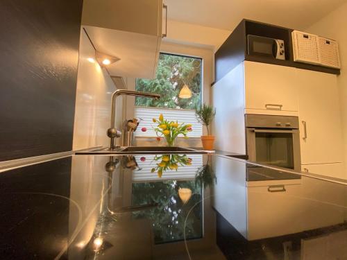 a kitchen with a sink and a window at Worker Space Kleve in Kleve